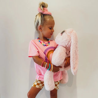 Child holding 20.5 inch plush bunny 
