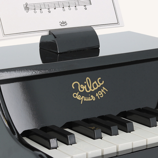 Black Wooden Piano with Sheet Music
